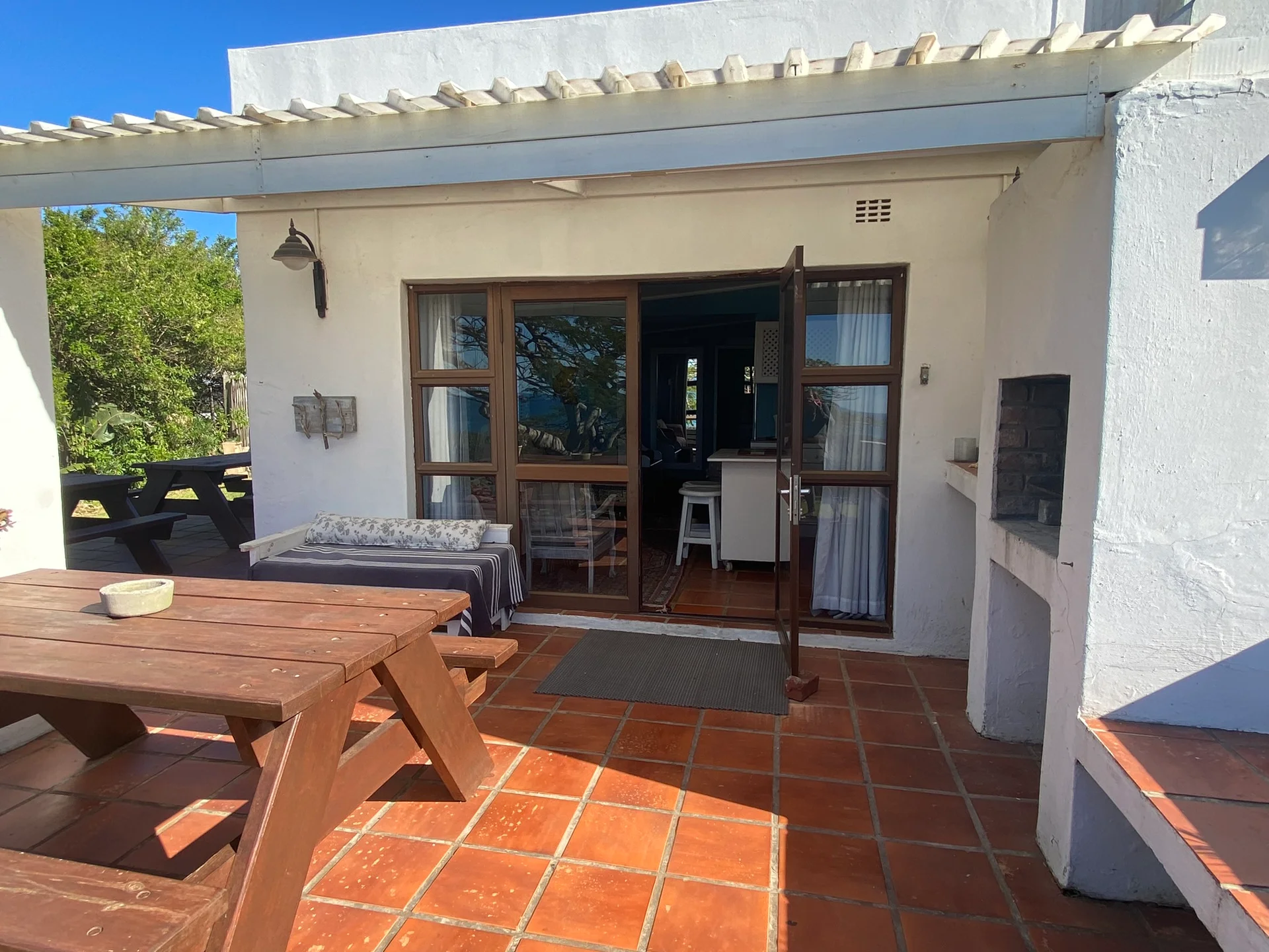 Outdoor braai area with wooden pergola